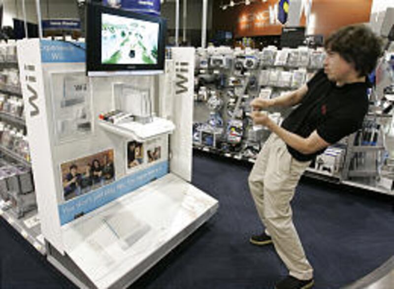 Jamie Moore watches a Nintendo Co.'s Wii game, which goes on sale today, at a Best Buy store Thursday in Mountain View, Calif.