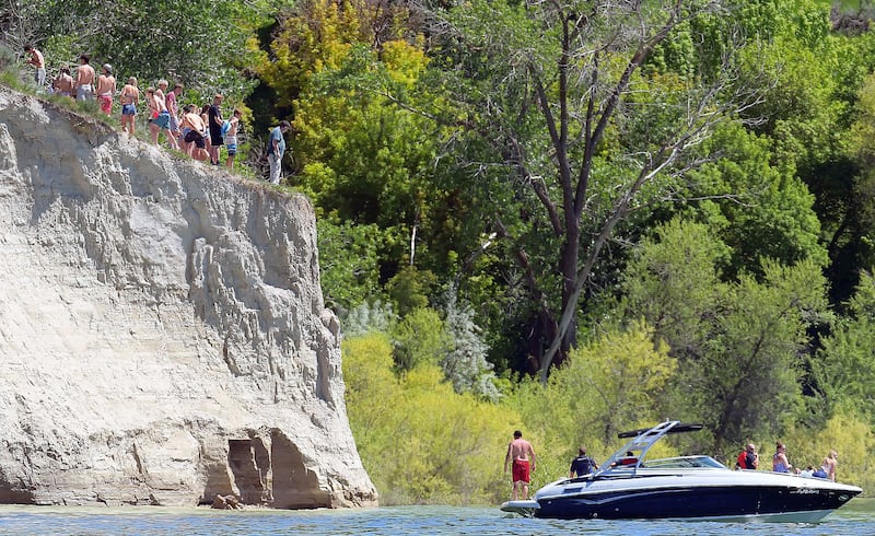 Boaters search for a drowning victim after he jumped off the "Big Toe" on Friday at Hyrum Reservoir.