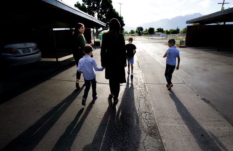 Baraa Huraideen, her sons, and interpreter Ghasaq Maiber walk to the Tumaini Welcome & Transition Center in South Salt Lake.