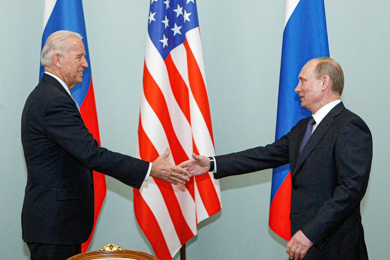 Vice President Joe Biden shakes hands with Russian Prime Minister Vladimir Putin.