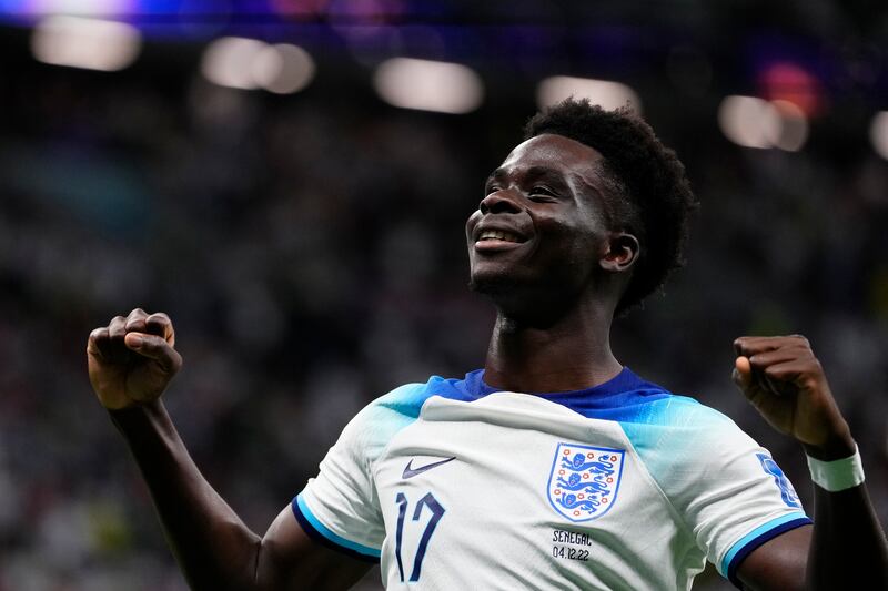 England’s Bukayo Saka celebrates after scoring a goal during the World Cup match between England and Senegal, Dec. 4, 2022.