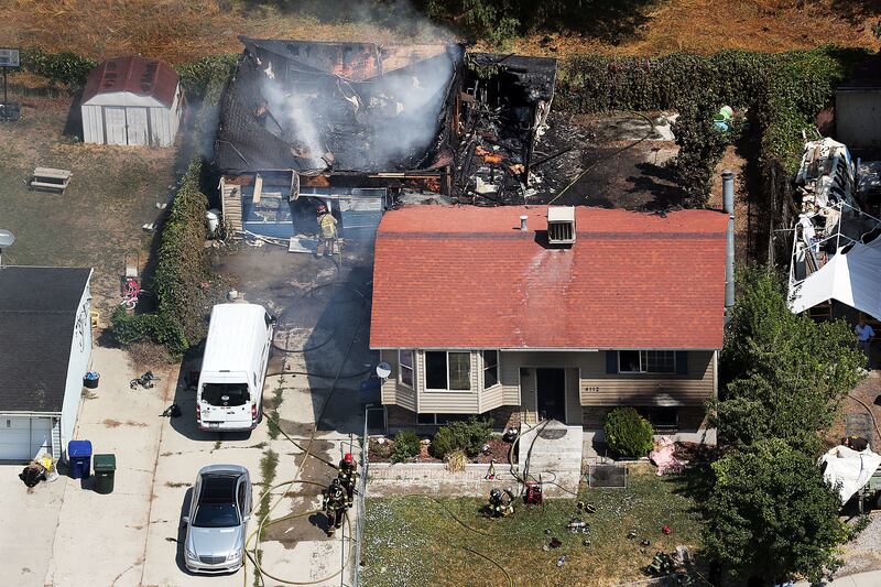 FILE - Firefighters work at the scene of a structure fire in West Valley City on Thursday, Aug. 9, 2018.