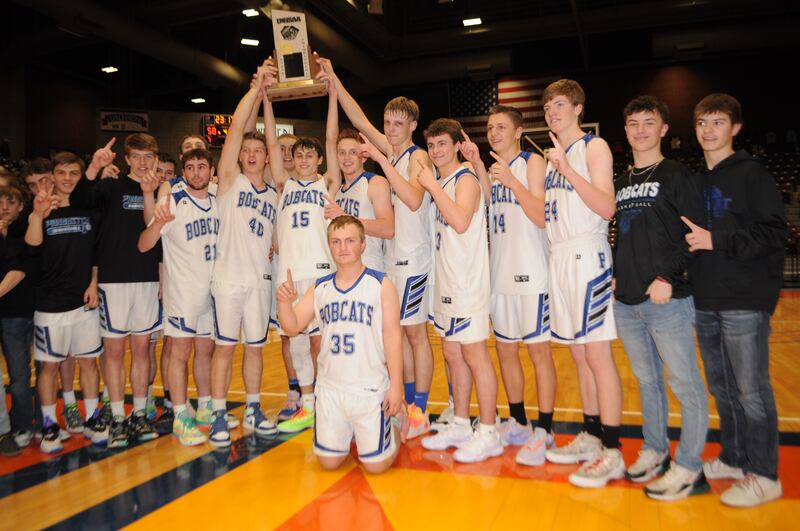 Panguitch High School players celebrate with the 1A basketball trophy Saturday, March 4, 2023, in Richfield after beating rival Piute for the state championship.
