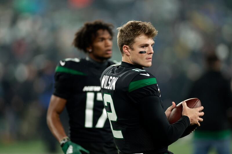 New York Jets quarterback Zach Wilson and wide receiver Garrett Wilson warm up before a game on Thursday, Dec. 22, 2022, in East Rutherford, N.J.