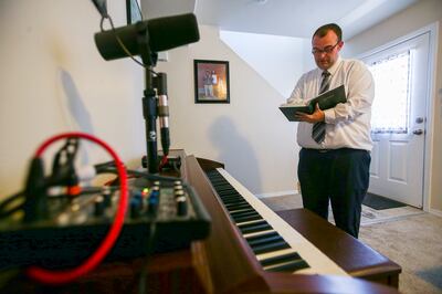 Michael Young, a school teacher, musician, songwriter, composer and member of the Tabernacle Choir, looks up a song as he prepares to work on a song at his Tooele home on Monday, July 15, 2019. Young partnered on more than 100 submissions for the hymnbook