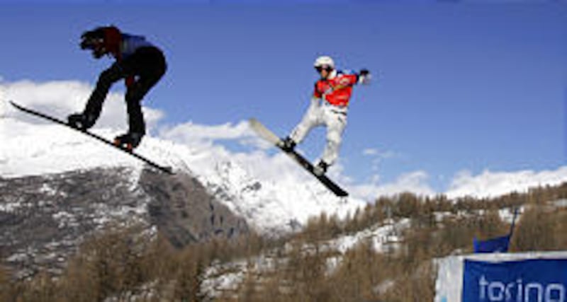 Slovakia's Radoslav Zidek, left, leads America's Seth Wescott in the championship run in the snowboardcross at the Torino Olympics. Wescott won the gold medal.