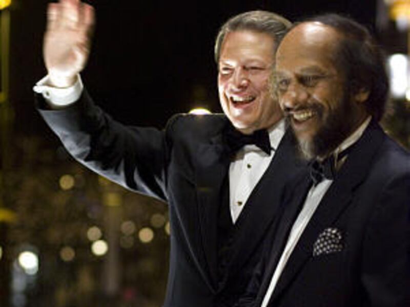 Nobel Peace Prize laureates Al Gore, left, and Rajendra K. Pachauri, chairman of the U.N. Intergovernmental Panel on Climate Change, greet the public in Oslo Monday.