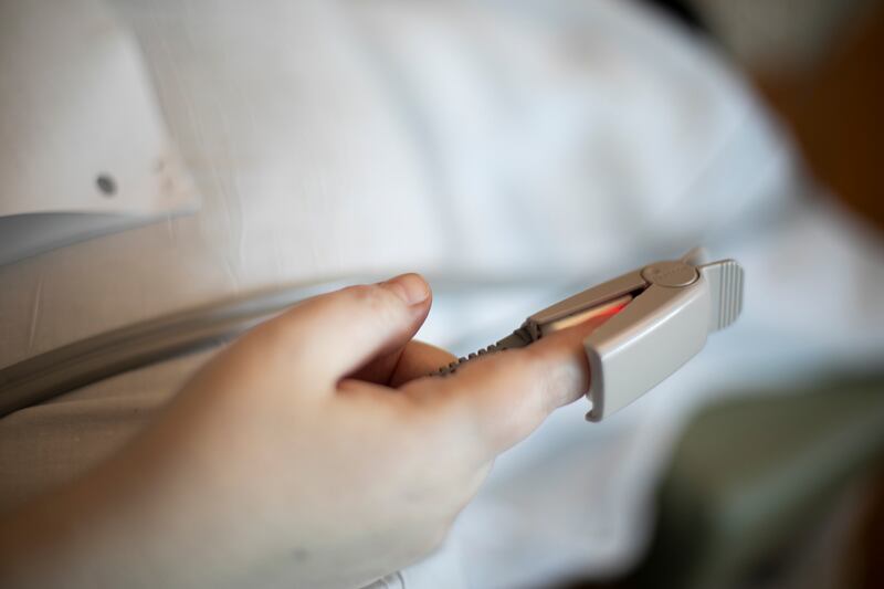 In this Aug. 8, 2020, photo a pulse oximeter is used to check a patient’s oxygen saturation level at a hospital in Portland, Ore.