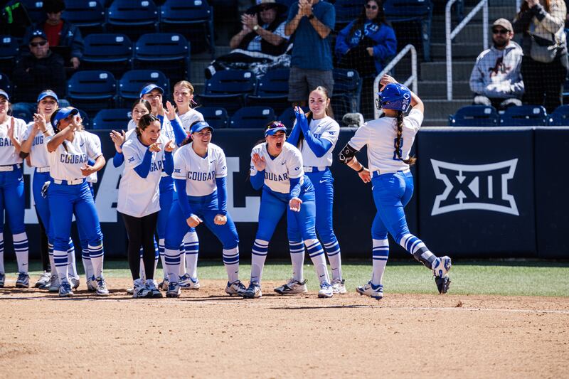 BYU players greet a teammate at the plate during game vs. Fresno State on April 14. This week the stakes will be higher when the Utes visit Provo for a three-game Big 12 series beginning Thursday.