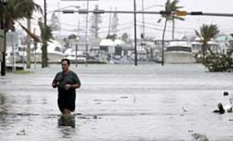 Key West resident Richard Yates walks down a flooded Truman Ave., one of the main streets heading south off the island, in Key West, Fla. after Hurricane Wilma came across the southwest part of the state Monday.