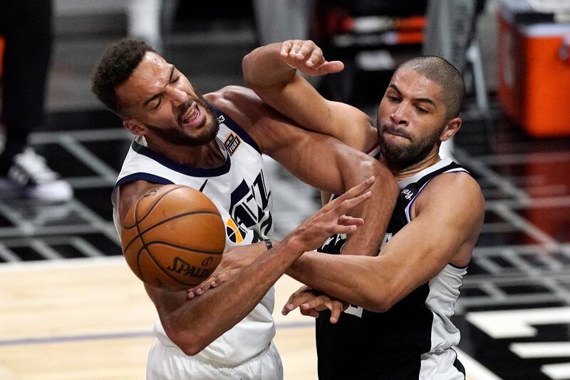 Utah Jazz center Rudy Gobert, left, blocks a pass intended for Los Angeles Clippers forward Nicolas Batum.