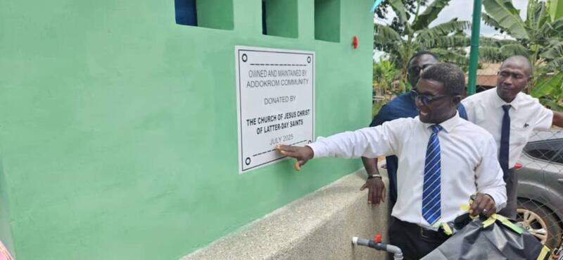 President Prosper Mensah, president of the Ejisu Ghana Stake, shows a plaque acknowledging the Church's donation of a borehole in Addokrom, Ghana, on July 22, 2025.