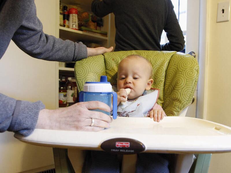 In this Wednesday, April 28, 2010 photo, Cara Palladino, left, and Isabelle Barker, background, feed their son, Will Palladino, 1, at their home in Philadelphia.