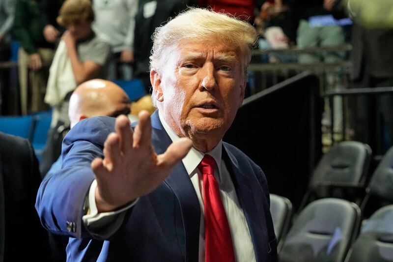 Former President Donald J. Trump waves as he arrives for the NCAA Wrestling Championships in Tulsa, Okla.