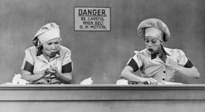 From left to right: Ethel (Vivian Vance) and Lucy (Lucille Ball) try to deal with candies coming too fast on a conveyor belt in a classic episode from "I Love Lucy."