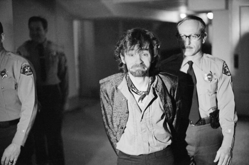 FILE - In this Dec. 21, 1970 file photo, Charles Manson reacts to photographers as he goes to lunch after an outbreak in court that resulted in his ejection, along with three female co-defendants, in the Sharon Tate murder trial. Authorities say Manson, c