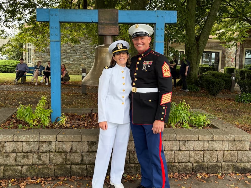 Left, Lt. j.g. Stacie Powell stands with her husband, retired Master Gunnery Sgt. Josh Powell, at Naval Station Newport in Newport, Rhode Island, on Sept. 26, 2025.