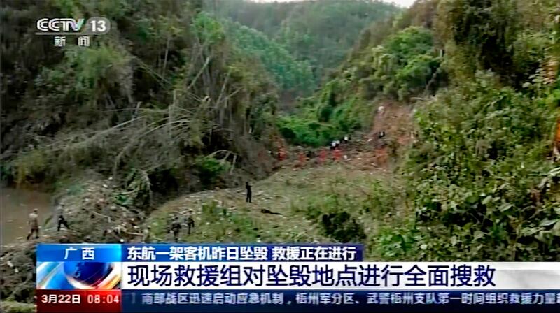 In this image taken from video footage run by China’s CCTV, rescuers and soldiers conduct search operations at the site of a plane crash in Tengxian County in southern China’s Guangxi Zhuang Autonomous Region, Tuesday, March 22, 2022.