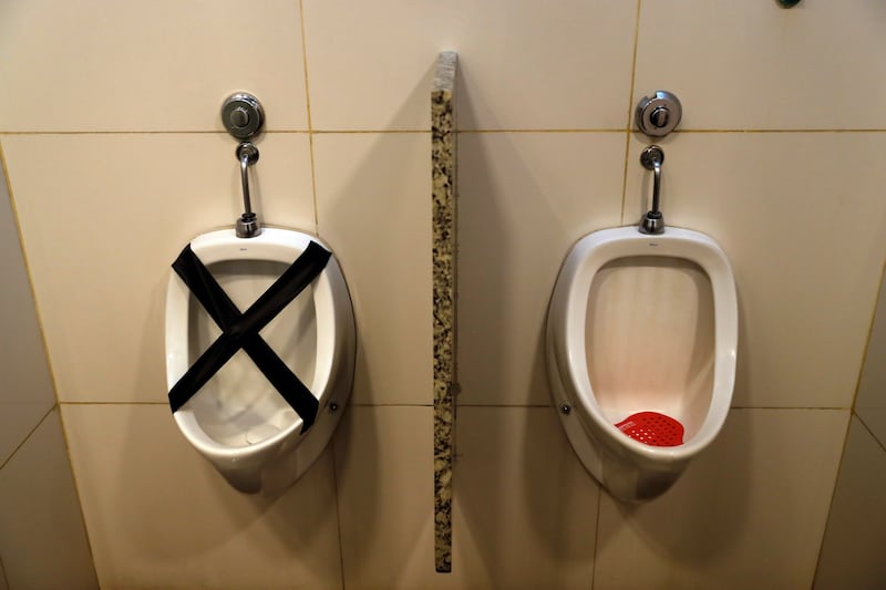 A urinal is marked with black tape to prevent use as a measure to encourage safe social distancing in a shopping mall bathroom in Asuncion, Paraguay, Friday, June 5, 2020. The government has eased the lockdown it put in place to curb the spread of the new coronavirus, authorizing the opening of some stores and restaurants as part of a plan coined, “Intelligent Quarantine.”