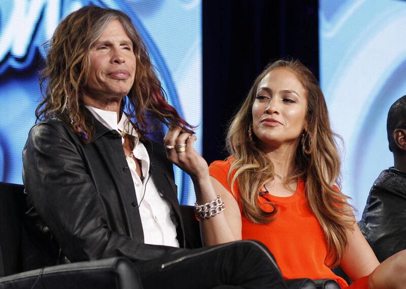 FILE - In this Jan. 8, 2012 file photo, American Idol judge Jennifer Lopez, right, plays with the hair of fellow judge Steven Tyler of Aerosmith as they participate in the American Idol panel at the Fox Broadcasting Company Television Critics Association