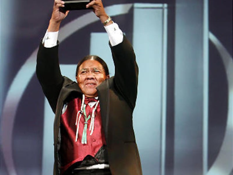 Travis Parashonts of Suhidutsing Technologies LLC. holds up his company's Entrepreneur of the Year Award at Friday's event in Salt Lake.