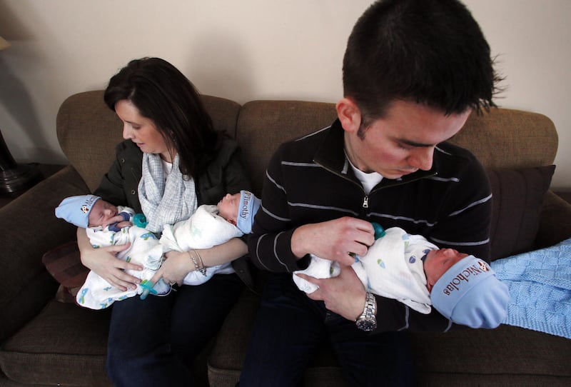 Michael and Lauren Whiteley, from left, check on their identical triplets Alexander, Timothy and Nicholas at their home in St. Clair Shores, Mich., Wednesday, Feb. 25, 2015. The brothers were born at 34 weeks via C-section on Jan. 25. About 4,300 triplet