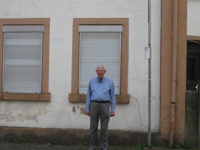 Utah historian Kent Powell in front of the school house in Oberkail, Germany. It is a building that figures prominently during the time Nels Anderson was in Germany as part of the American occupation in World War I.