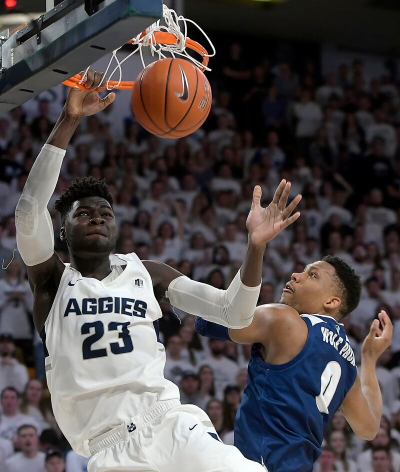Utah State center Neemias Queta (23) dunks the ball as Nevada forward Tre'Shawn Thurman (0) defends during an NCAA college basketball game, Saturday, March 2, 2019, in Logan, Utah. (Eli Lucero/The Herald Journal via AP)