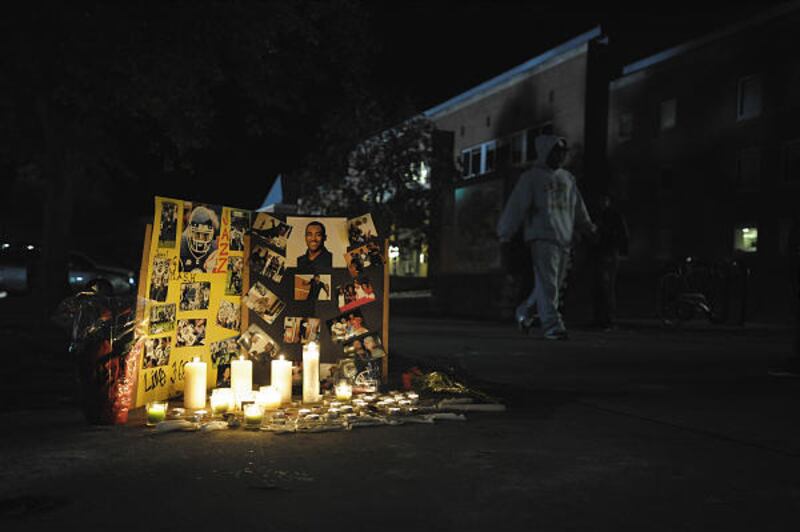 A candle vigil is displayed Monday at the spot where Connecticut football player Jasper Howard was killed outside the Student Union on campus in Storrs, Conn.