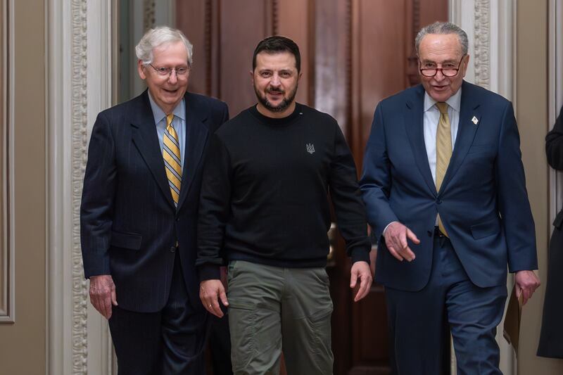 Ukrainian President Volodymyr Zelenskyy, center, is escorted by Senate Minority Leader Mitch McConnell, R-Ky., left, and Senate Majority Leader Chuck Schumer, D-N.Y., and as he visits Washington on Dec. 12, 2023.