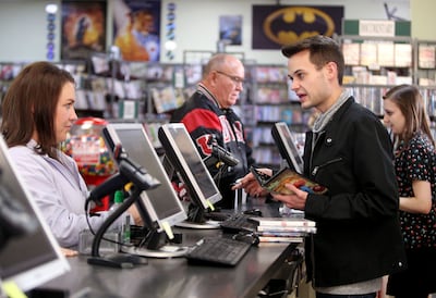 Brendon Elwood, right, helps Robyn Christensen check out videos at Top Hat Video in Bountiful on Friday, Jan. 26, 2018.