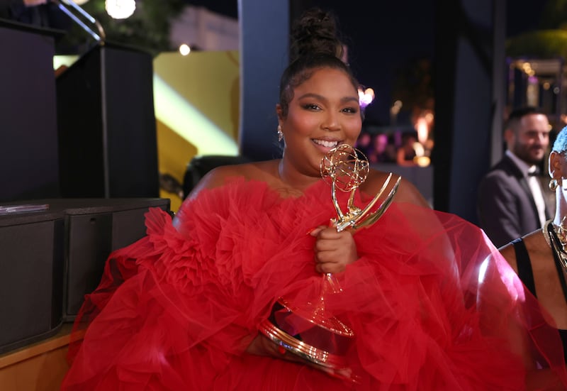 Lizzo holds Emmy trophy in poofy red dress