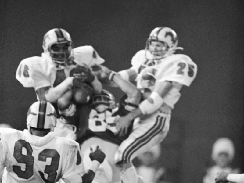 BYU receiver Clay Brown goes up for a pass in the end zone with SMU defenders Dick Blaylock, right, Wes Hopkins, center, and Russell Washington on the last play of the Holiday Bowl game, Dec. 20, 1980.