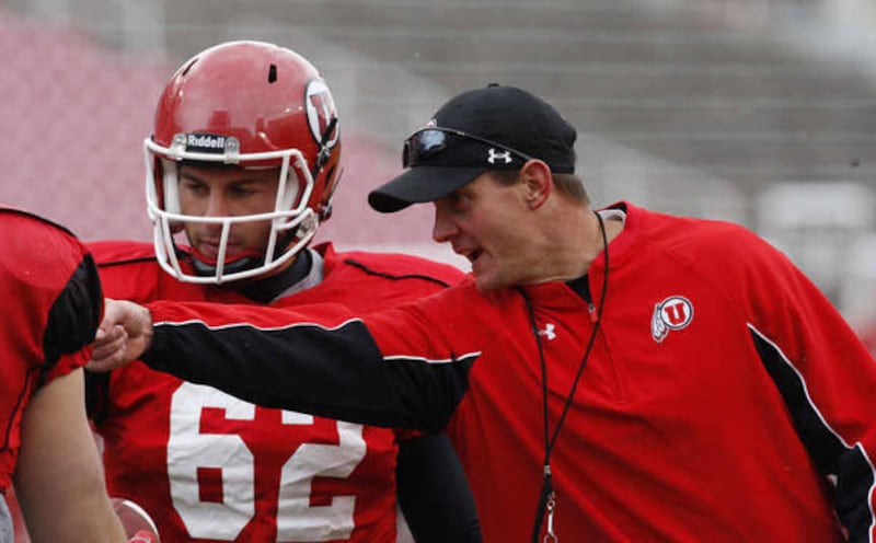 A.J. Merlino gets instruction from coach Jay Hill during Univerisity of Utah football practice Tuesday, April 16, 2013, in Salt Lake City.
