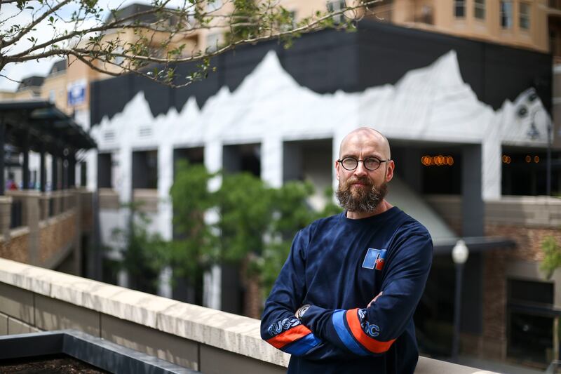 Muralist Havoc Hendricks poses for a portrait by a mural he recently completed at the Gateway Mall in Salt Lake City on Thursday, June 13, 2019.