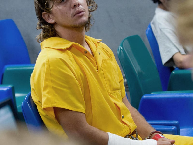 FILE - In this Aug. 11, 2011 photo, Dylan Stanley Dougherty awaits advisement at the Pueblo County Sheriff's Office detention center in Pueblo, Colo. Dylan Stanley Dougherty got out of his cell through a plumbing access panel and passed a note to his s