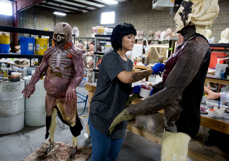 Mikaela Kester, fabrication department head, paints a Dark Blood character in Evermore Park's design shop in Pleasant Grove on Thursday, Sept. 13, 2018.