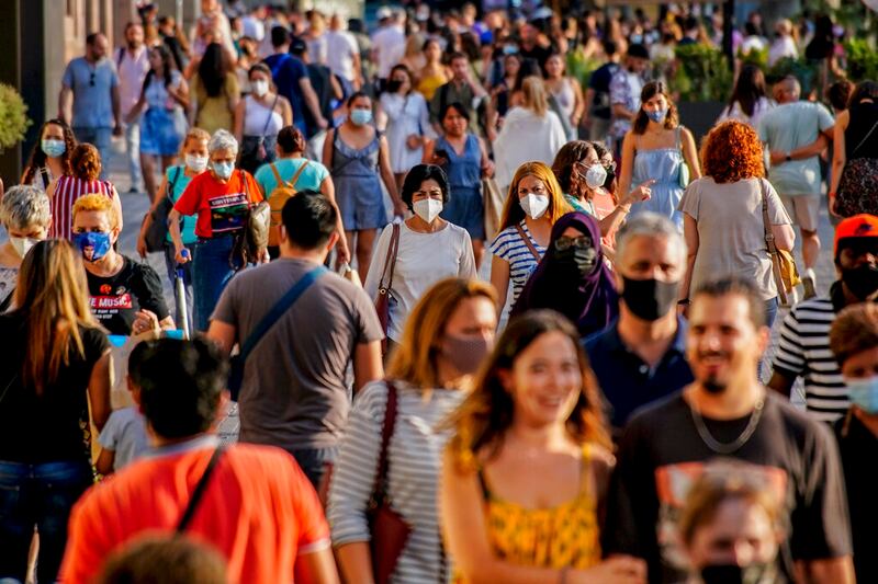 People in downtown Barcelona, Spain, wearing masks.