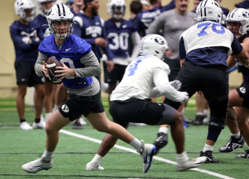 BYU quarterback Kedon Solvis looks to make a pass during opening day of BYU spring football camp.