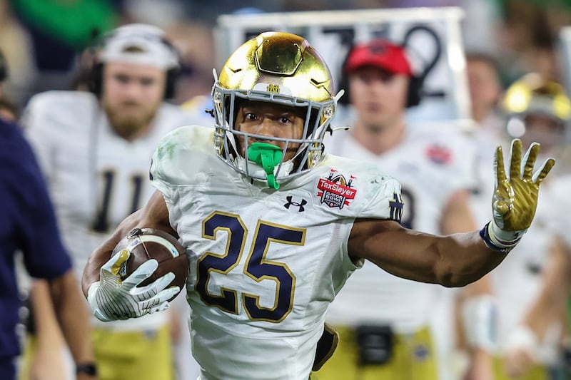 Notre Dame running back Chris Tyree (25) runs the ball during a game against South Carolina, Dec. 30, 2022, in Jacksonville.