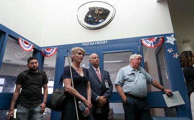 Kristen Cox, executive director of the Governor's Office of Management and Budget, and Dallas Earnshaw, Utah State Hospital superintendent, center, lead a tour of the Inpatient Forensic Restoration Unit at the Provo hospital on Thursday, July 19, 2018.