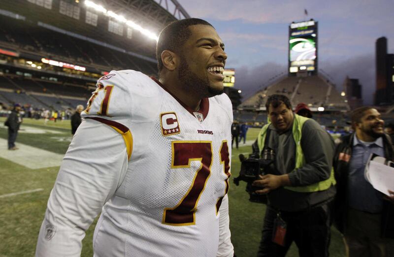 FILE - This Nov. 27, 2011 file photo shows Washington Redskins' Trent Williams celebrating the Redskins' 23-17 win over the Seattle Seahawks in an NFL football game, in Seattle. It's something that's "added to the Redskins drama." That's the reaction Mond