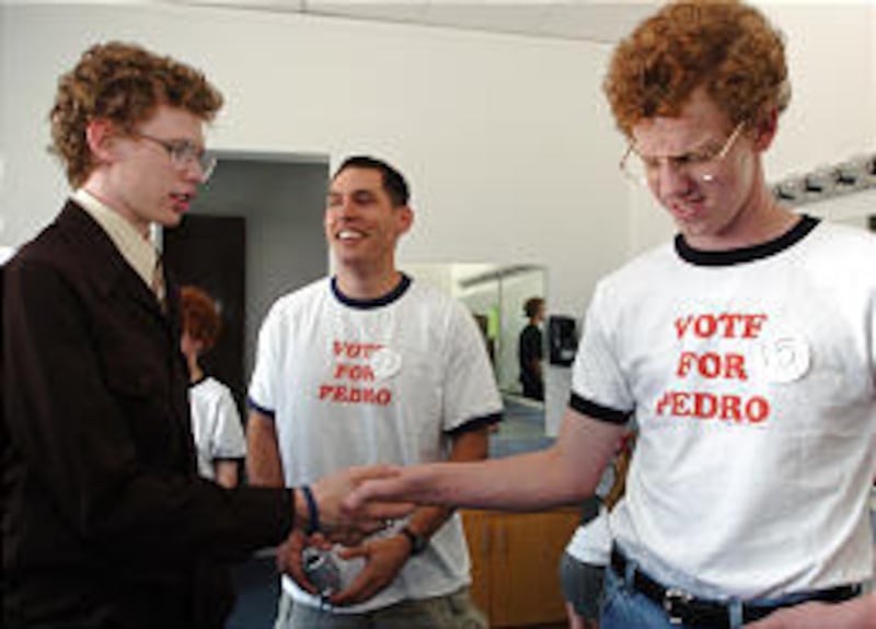 Tucson resident James Lee, 17, left, shakes hands with Dallas native Bryan Demke, 15, Saturday at Preston High School in Preston, Idaho. The two were awaiting results of the Napoleon Dynamite Festival contests for Napoleon look-alike, moon-boot dance and
