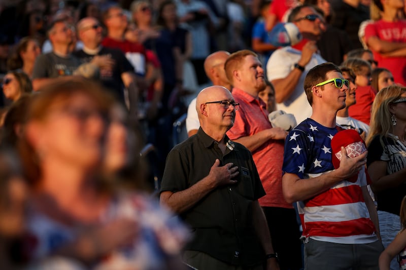 Members of the audience listen to the national anthem during Stadium of Fire at LaVell Edwards Stadium in Provo on Wednesday, July 4, 2018.