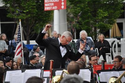 Music director Sterling Poulson leads the 23rd Army Band of the Utah National Guard and the Choral Arts Society of Utah at the Armed Forces Day concert on Saturday, May 18, 2019, at the Gallivan Center.
