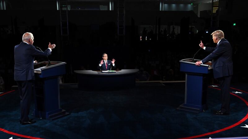 President Donald Trump and Democratic presidential candidate former Vice President Joe Biden talk in the first presidential debate Tuesday, Sept. 29, 2020, at Case Western University and Cleveland Clinic, in Cleveland, as moderator Chris Wallace of Fox News speaks.
