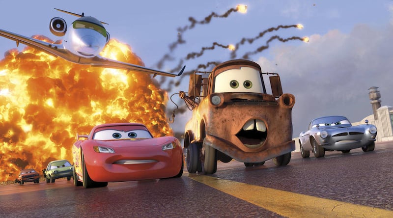 In this film publicity image released by Disney-Pixar, animated characters Lightning McQueen, voiced by Owen Wilson, foreground left, Mater, voiced by Larry the Cable Guy, center, and Finn McMissile, voiced by Michael Caine, right, are shown in a scene fr