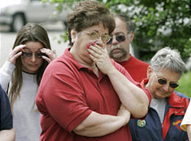 Maytag worker Sandy Hannagan, center, and fellow Maytag workers listen to Iowa Gov. Tom Vilsack speak Wednesday in Newton, Iowa. The Newton plant and headquarters will close in October 2007.