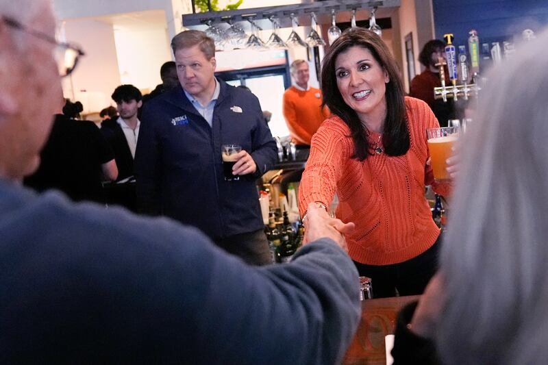Republican presidential candidate Nikki Haley shakes hands with a patron during a campaign stop on Jan. 22, 2024, in Concord, N.H.