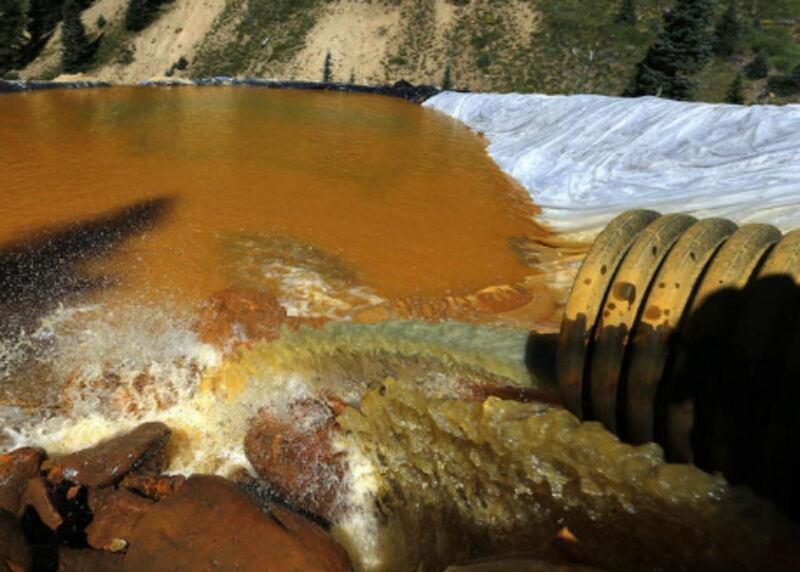 FILE - In this Aug. 14, 2015, file photo, water flows through a series of sediment retention ponds built to reduce heavy metal and chemical contaminants from the Gold King Mine wastewater accident, in the spillway downstream from the mine, outside Silvert